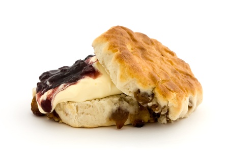 Fresh fruit scone with clotted cream and jam isolated on whiteの写真素材