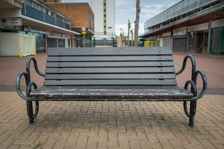 BRACKNELL, UK - AUGUST 11, 2013: A bench in an empty highstreet in the Berkshire town of Bracknell. Awaiting demolition to make way for re-development.のeditorial素材