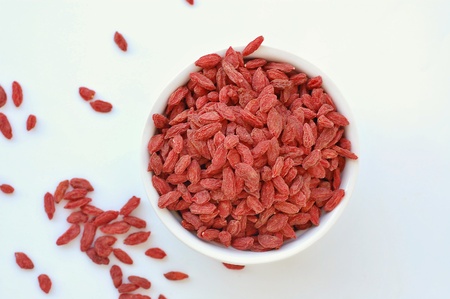 Chinese goji in the bowl on the white background, overhead horizontal view