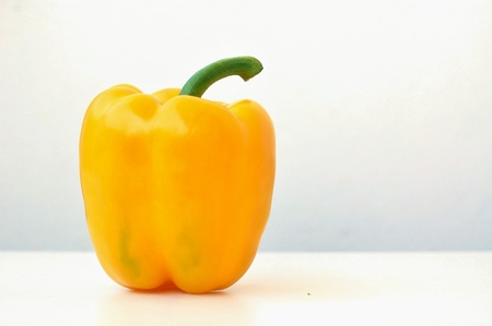Yellow pepper on the white background, front horizontal viewの写真素材