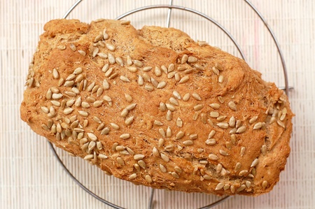 Bread with sunflower seeds on the white background, overhead horizontal view