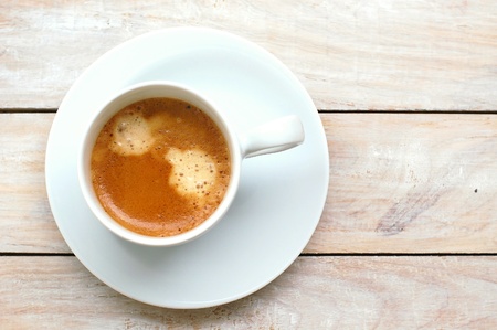 Espresso in the cup on the wooden background, overhead horizontal viewの写真素材