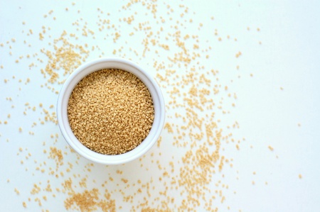 Wholegrain couscous in the bowl on the white background, overhead horizontal viewの写真素材