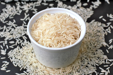 Basmati rice in the bowl on the black background, front horizontal viewの写真素材