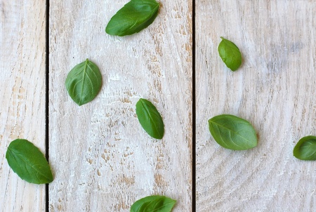 Leaves of basil on the wooden background, overhead horizontal viewの写真素材