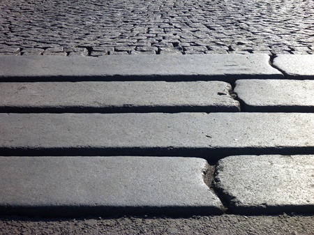 a detail of steps in a grey paved sidewalkの写真素材