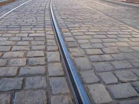 a tram line in a cobble stone pavementの写真素材