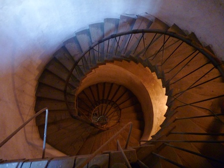 an old historical round staircase with railing