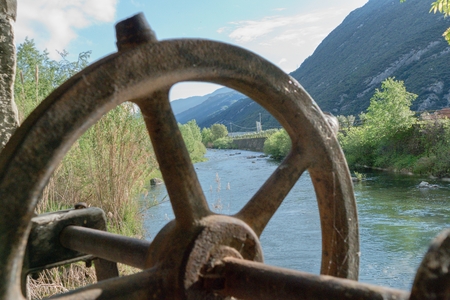 old water work structure with wheels on a riverの写真素材