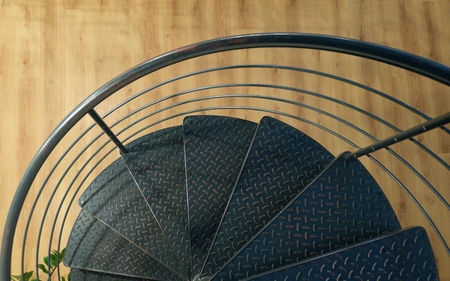 detail od metal round stairs with wooden floor