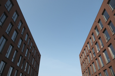 a modern office building with red brick facadeの写真素材