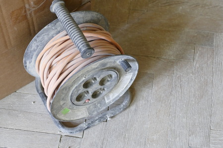 a roll of an electrical cable on a floorの写真素材