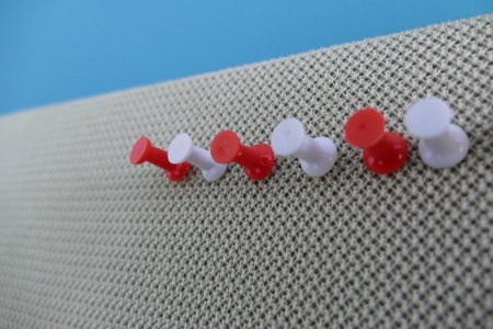 a colored pin in an office pinboardの写真素材