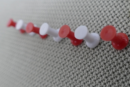 a colored pin in an office pinboardの写真素材