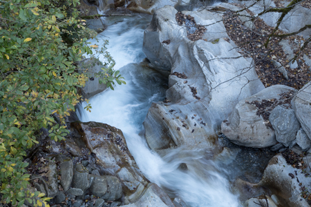 beautiful mountain stream in rocks in autumn seasonの写真素材
