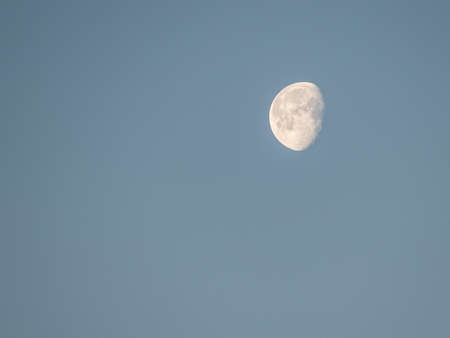more than a half moon on the blue sky
