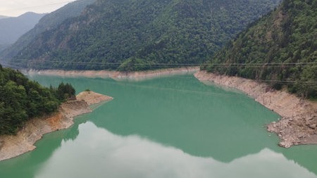 enguri dam on a river in georgia with power plantの写真素材