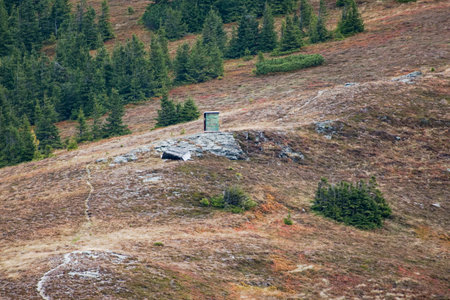 Mountain landscape with a small house on top of a hill.の写真素材