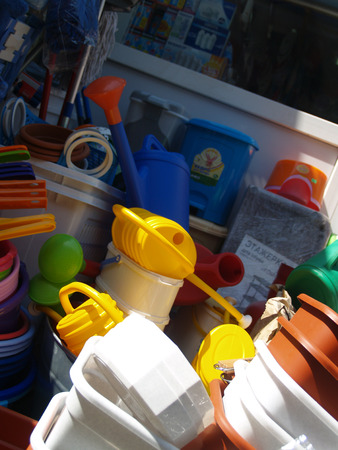 Mess of plastic household objects in small market-placeの写真素材