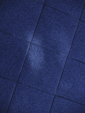 Closeup of a surface of textured blue tilesの写真素材