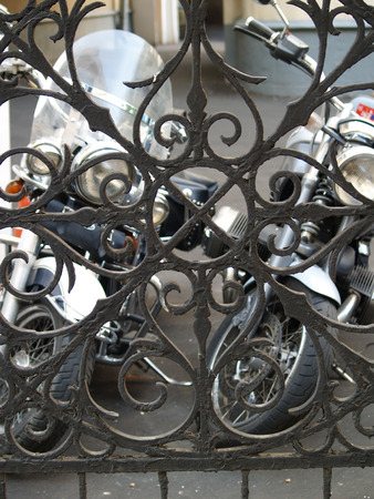 Iron fence and two motosの写真素材