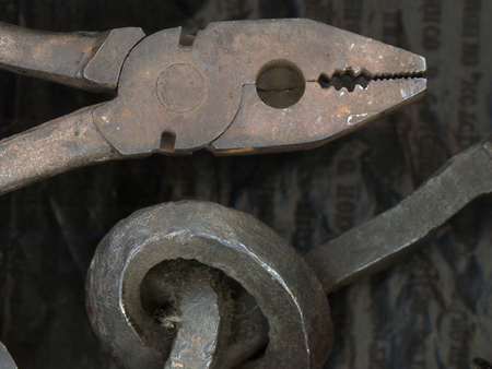 Rusty old iron objects against black old carbon paperの写真素材