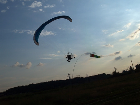 Paraglider against cloudy skyの写真素材