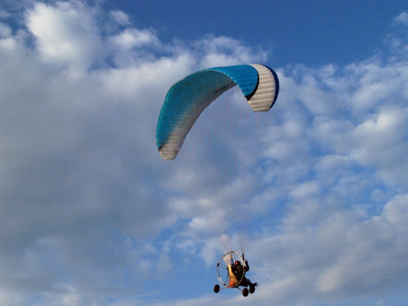Paraglider against cloudy skyの写真素材