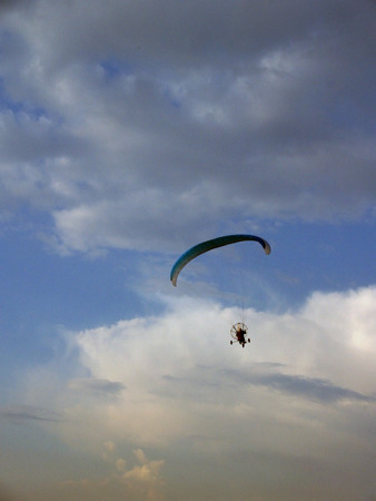 Paraglider against cloudy skyの写真素材