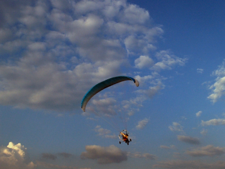 Paraglider against cloudy skyの写真素材