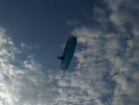 Paraglider against cloudy skyの写真素材