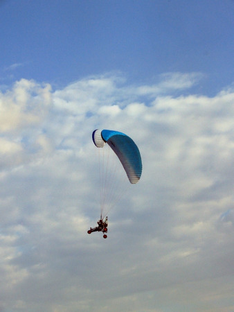 Paraglider against cloudy skyの写真素材