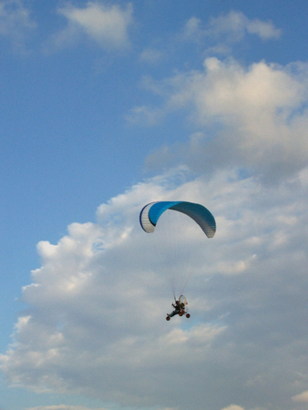 Paraglider against cloudy skyの写真素材