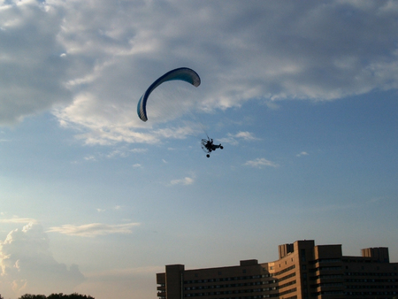 Paraglider against cloudy skyの写真素材