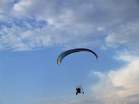 Paraglider against cloudy skyの写真素材