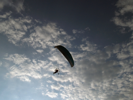 Paraglider against cloudy skyの写真素材