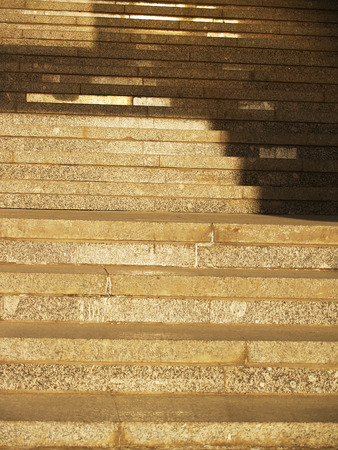 Wide stone stairway with pattern formed by shadows and highlights