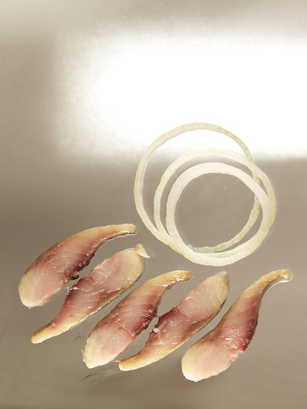 Small slices of salted fresh humpback salmon fillets with onion ringsの写真素材