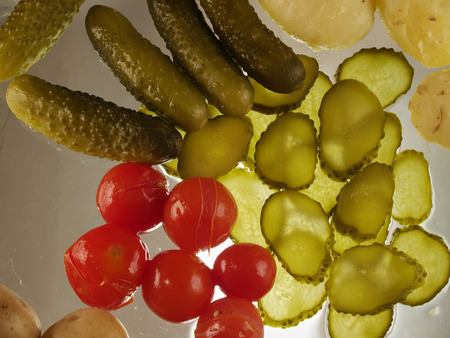 The traditional snack in the village. Boiled potatoes with pickled cucumbers and tomatoes. Flat lay. Back litの写真素材