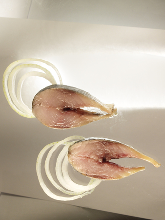 Two slices of salted fresh humpback salmon fillets with onion ringsの写真素材
