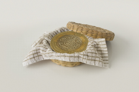 Ten Mexican Pesos coin inside a tortilla basket.の写真素材