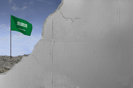 Saudi Arabia flag behind a concrete wall.の写真素材