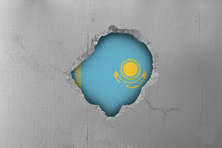 Kazakhstan flag behind a concrete wall.の写真素材