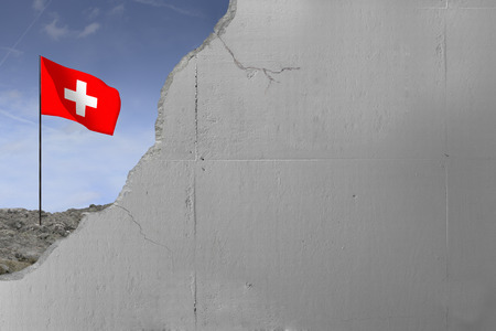 Switzerland's flag behind a concrete wall.の写真素材