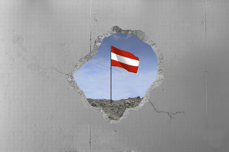 Austrian flag behind a concrete wall.の写真素材