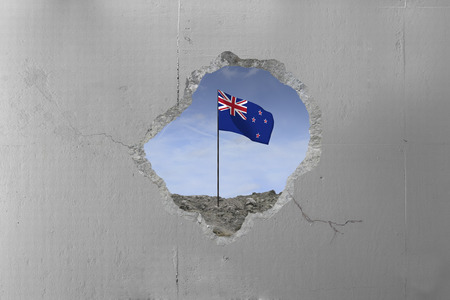 New Zealand flag behind a concrete wall.の写真素材