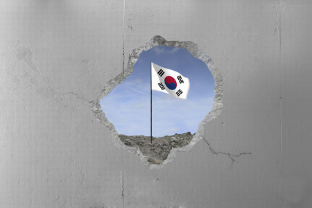 South Korean flag behind a concrete wall.の写真素材