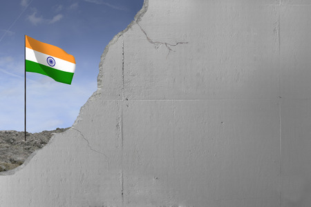 Indian flag behind a concrete wall.の写真素材