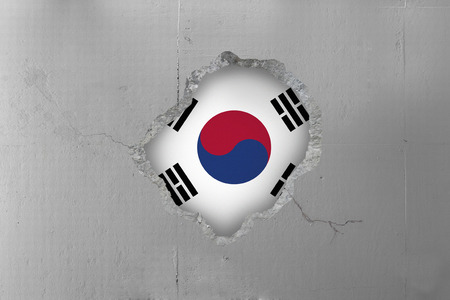 South Korean flag behind a concrete wall.の写真素材
