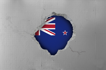New Zealand flag behind a concrete wall.の写真素材